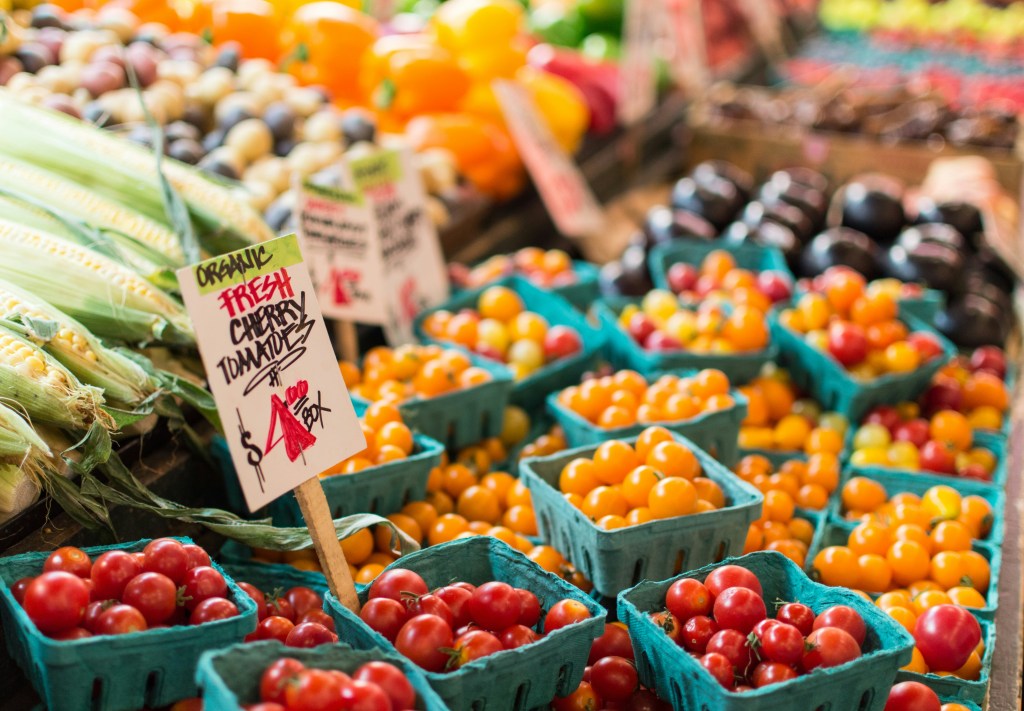 close up photo of cherry tomatoes at a market